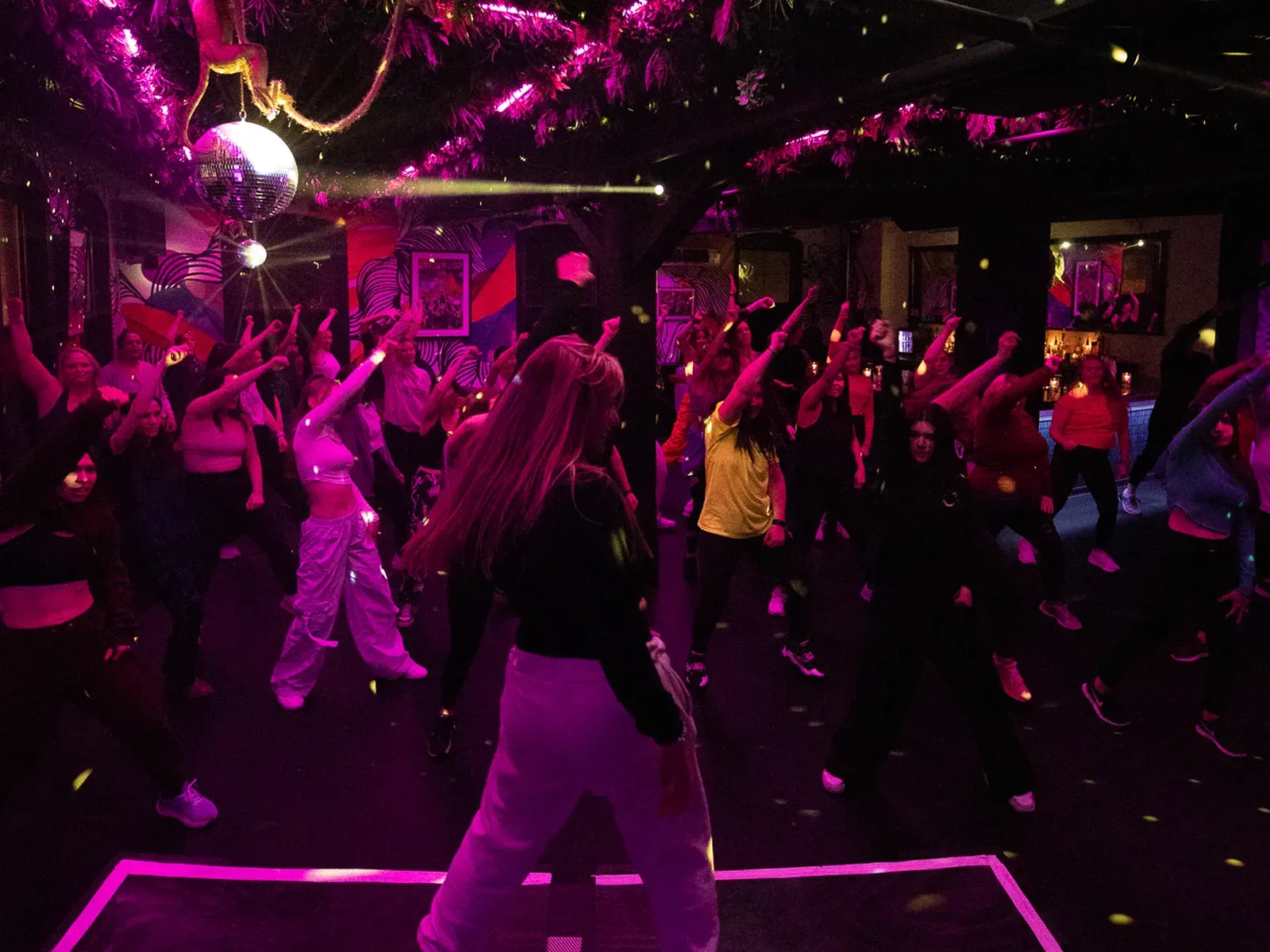 A room of adults following along together at a C3 Dance Fit class