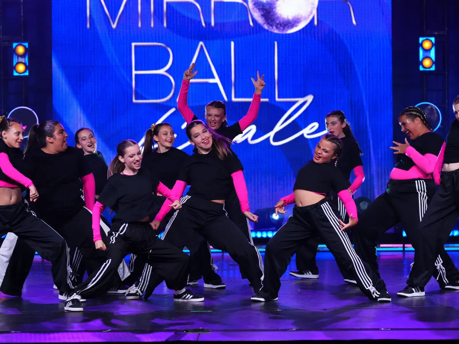 A C3 youth team hitting a formation together on the Mirror Ball stage